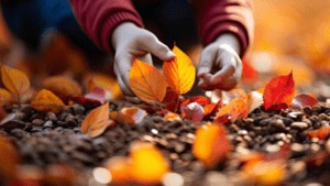 Children's hands collecting dry autumn leaves in the park