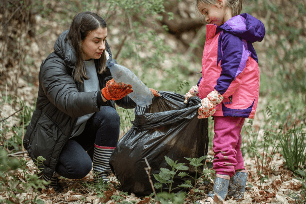 Mother and child littering with polythene in the forest