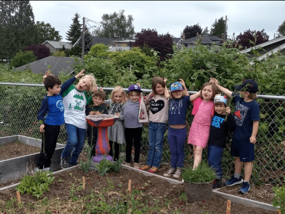 Some children are standing next to the winter garden