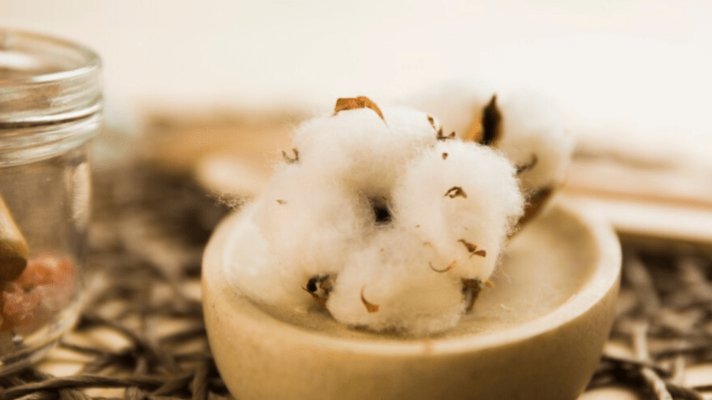 Soft raw cotton ball on marble container