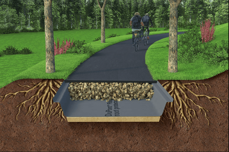 A cross-section of a pathway showing a below-ground stabilization system beneath, with cyclists on the path above.