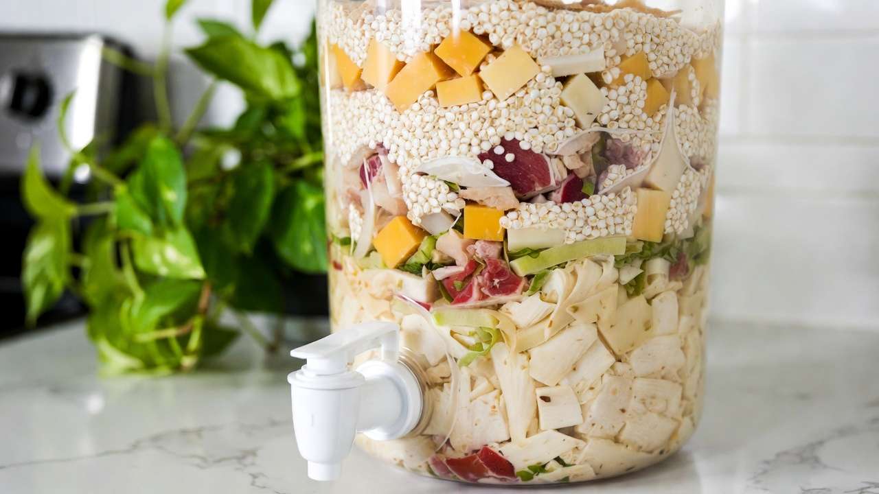 Bokashi bucket fermenting dairy and meat scraps safely with bran for odor-free pre-composting in plant lover's home