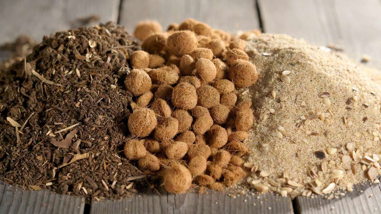 Close-up of compost, coco coir, and coarse sand — key ingredients in DIY raised bed soil blend