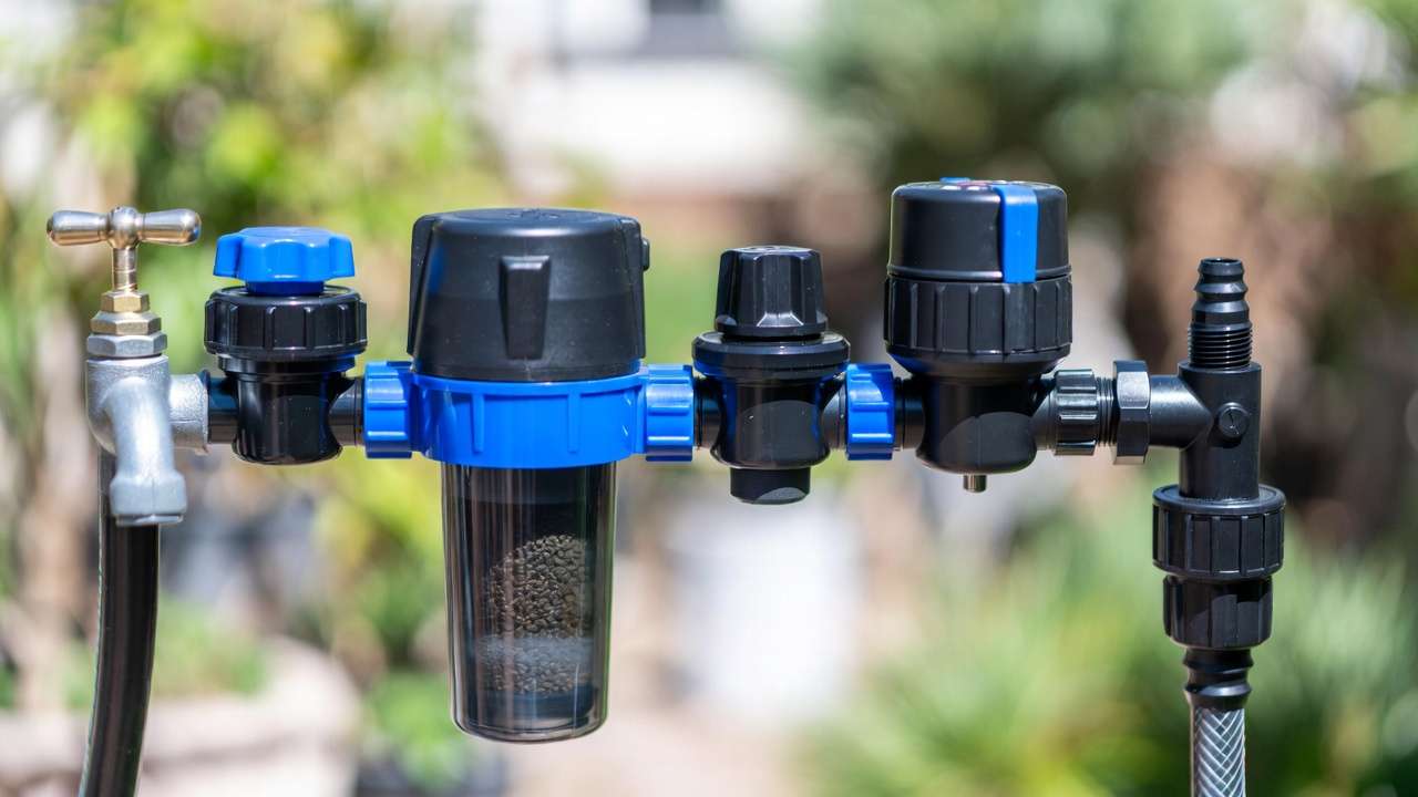 Properly assembled drip irrigation head unit with filter, pressure regulator, and timer connected to water source