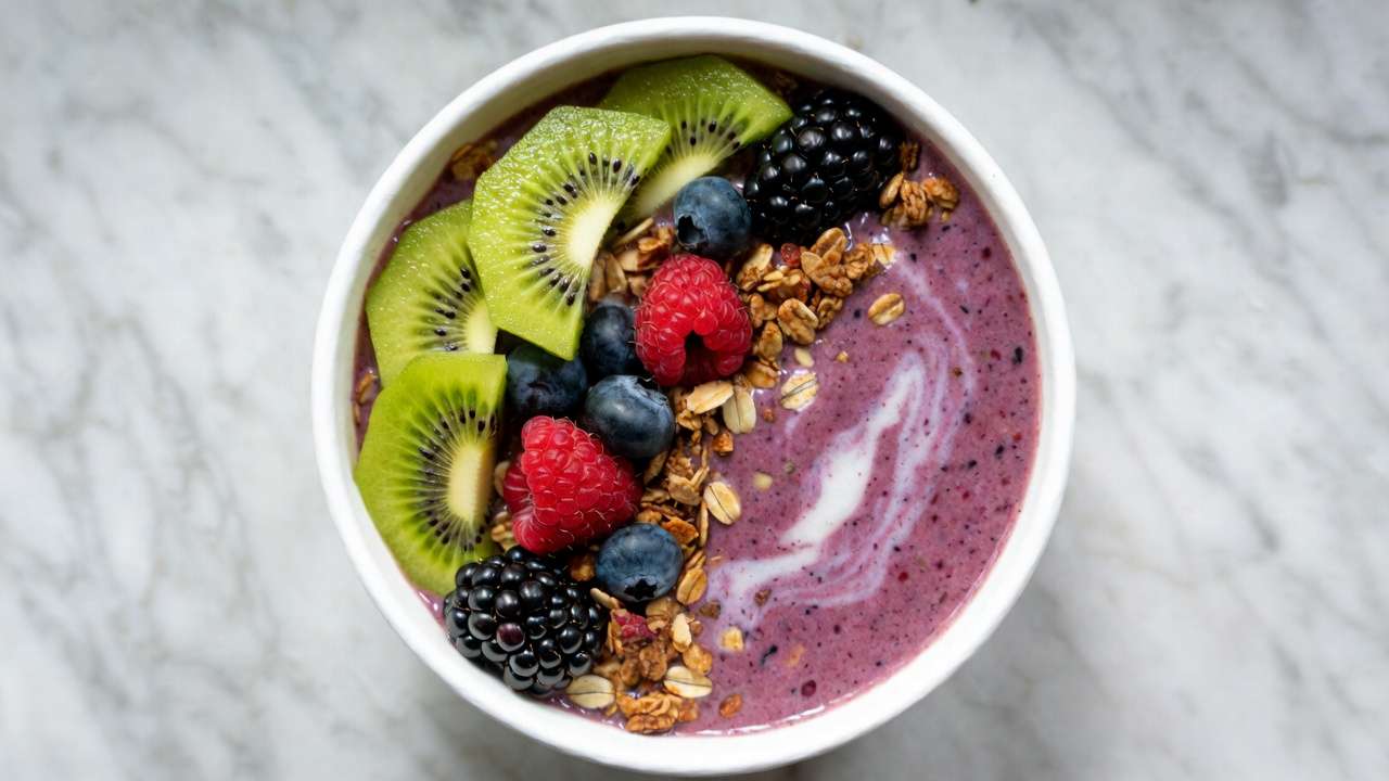 Healthy smoothie bowl using thawed vacuum-sealed homegrown berries mango and kiwi with fresh toppings