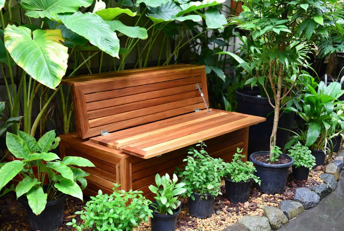 Well-maintained multifunctional furniture in humid small garden with healthy plants