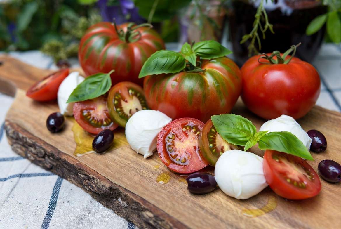 Fresh Caprese salad made with sliced Mr Stripey bi-color tomatoes