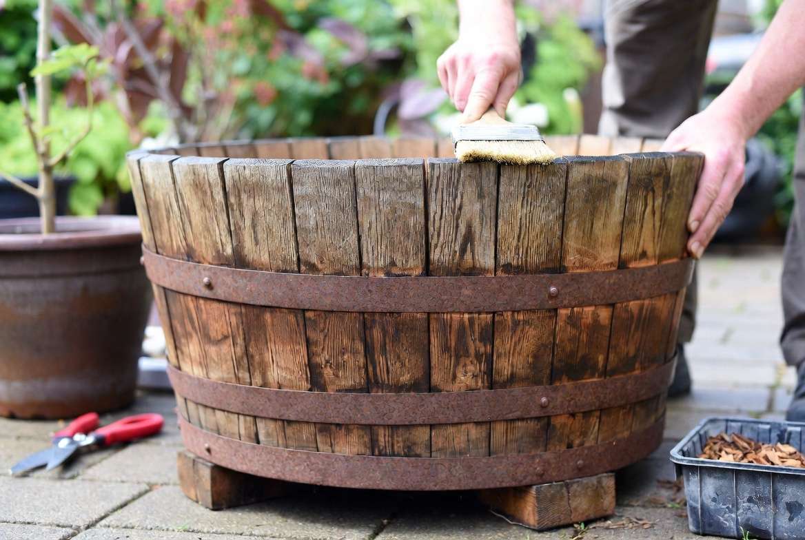 Maintaining and protecting wooden barrel planters from rot and weather
